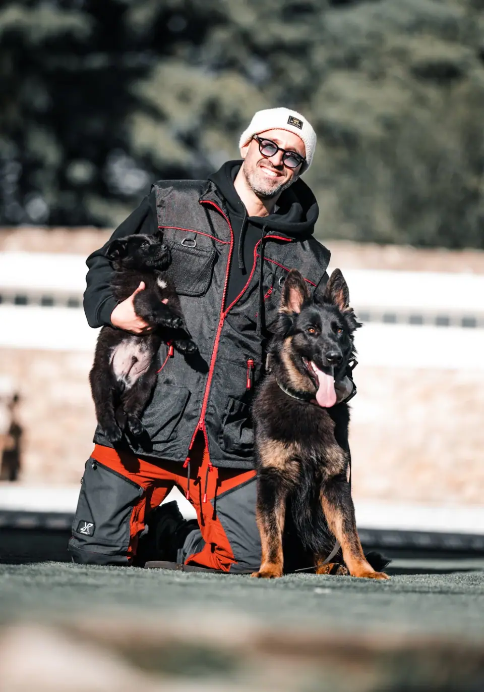 Rui Navarro, founder of TYR Protection Dogs, with two German Shepherds
